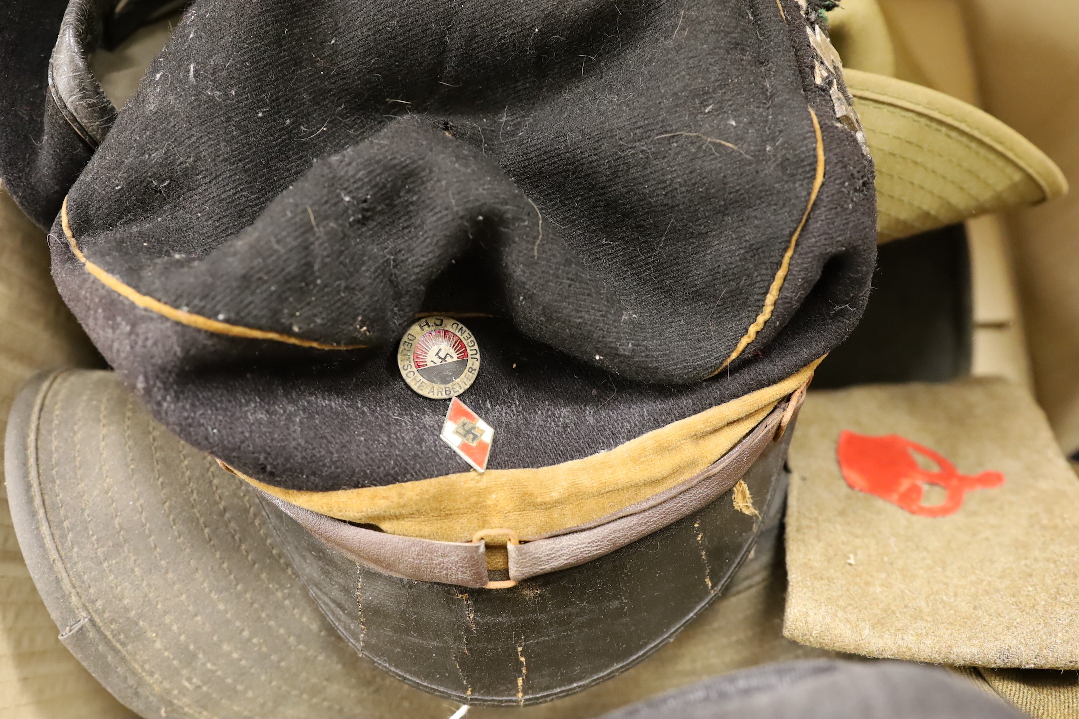 Two 1930’s German caps and an assortment of British army caps